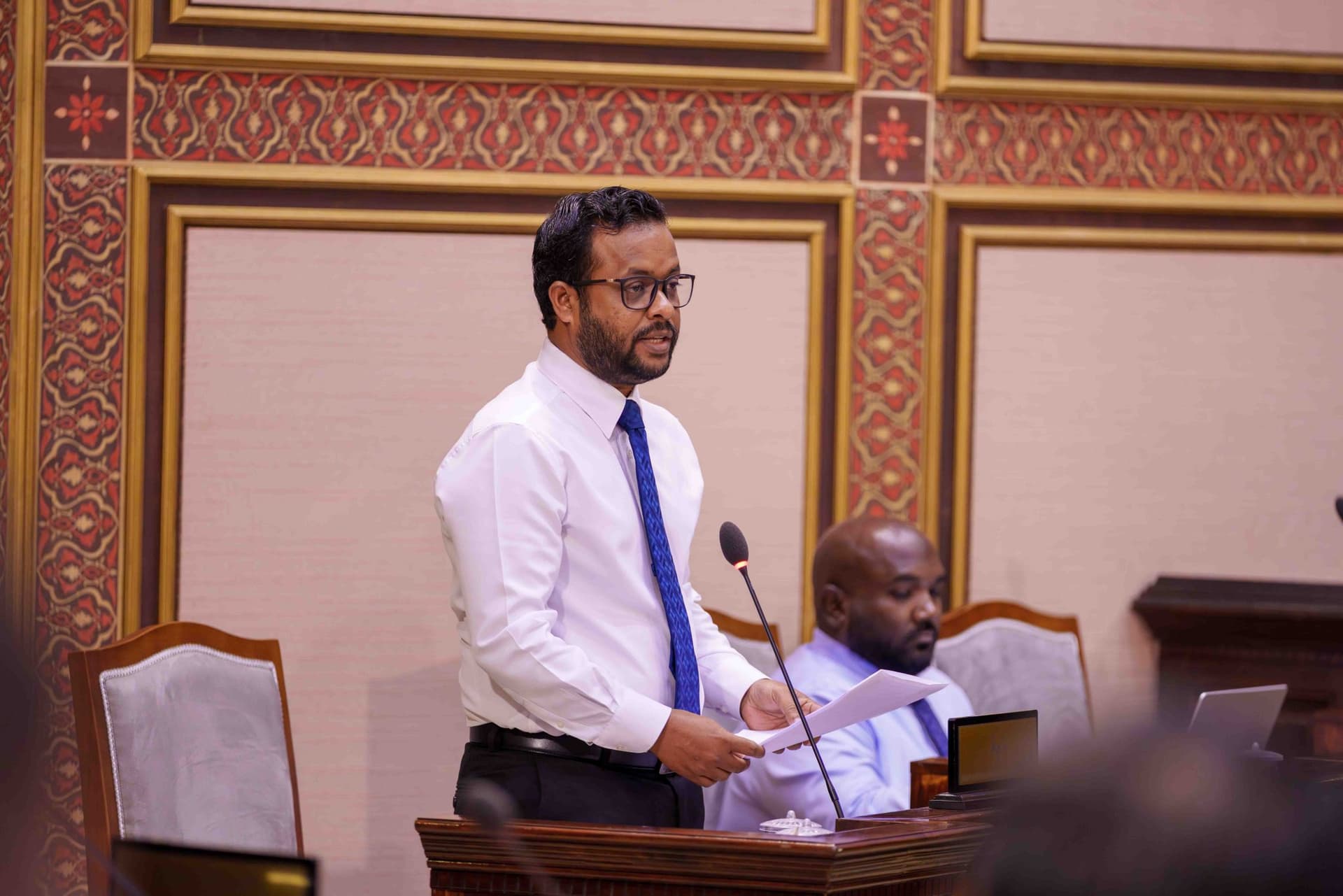 Infrastructure, Housing and Urban Development Minister Dr. Abdulla Muththalib speaks during a parliamentary sitting while responding to questions on the progress of the Gulhifalhu reclamation project and related land plots. | Photo: The People’s Majilis