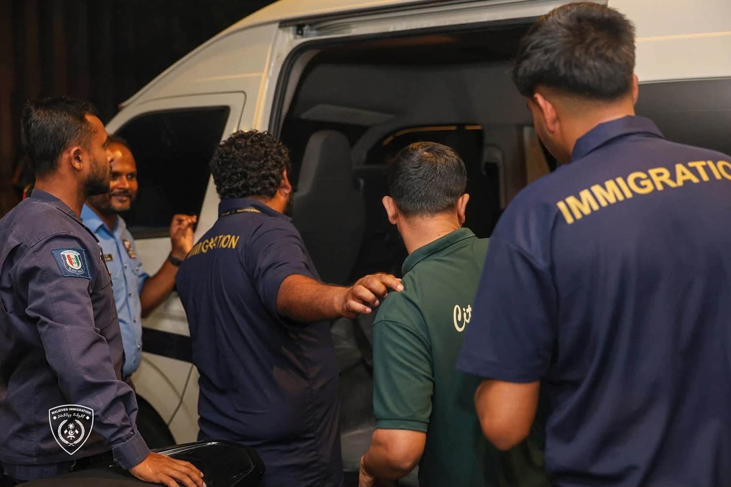 Maldives Immigration officers escort undocumented expatriates during an enforcement operation as part of the ongoing effort to identify and repatriate illegal migrants. | Photo: Immigration 